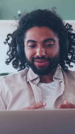 engaging conversation with a middle eastern man in headphones at home