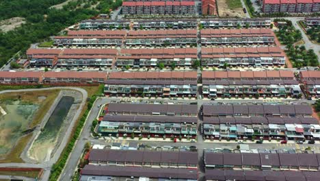 aerial views from a drone flyover reveal the goodview heights residential neighborhood featuring rows of double-storey terraced houses constructed by shl consolidated berhad, malaysia, southeast asia