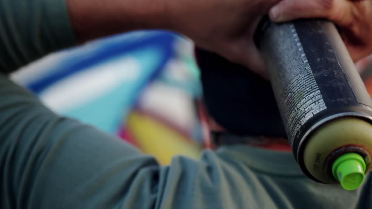 Graffiti artist with hands behind head 4k