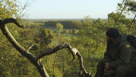 man resting and enjoying the beautiful landscape shot of peaceful nature in sunlight