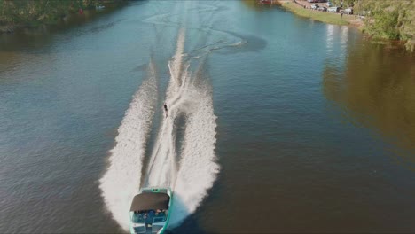 aerial view of riding speedboat and waterski on waters