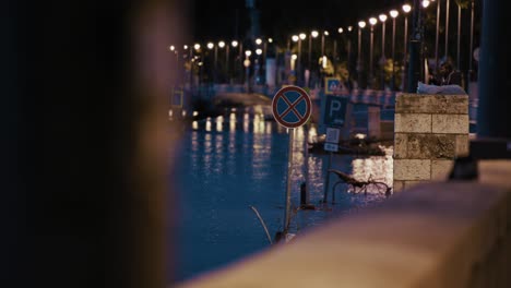 flooded street with traffic signs submerged and reflections of street lights, budapest flood 2024