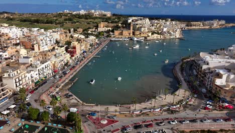 Aerial-drone-view-of-Marsascala-harbour-on-a-sunny-day,-Malta