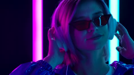 woman listening to music in neon lights