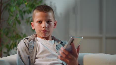 Boy-finishes-talking-with-mom-turning-to-camera-and-smiling