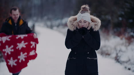 mujer dando la mano a su novio en un paseo por el bosque en invierno 1