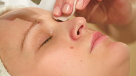 young woman getting ultrasonic cleaning of a nose