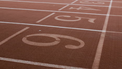 close-up of running track lanes with numbers