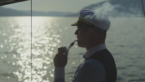 captain smoking a pipe at sea