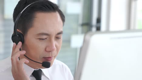 businessman wearing headset working actively in office