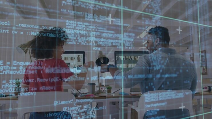Colleagues noticing code overlay and discussing debugging before bumping fists and resuming coding