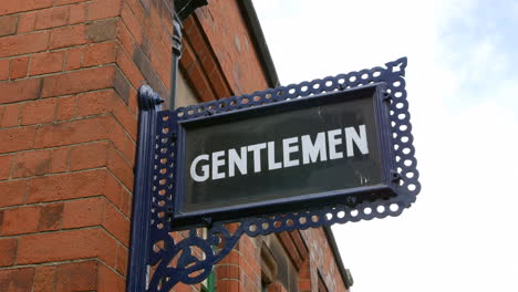 a vintage antique gentlemen toilet wash rest room sign at a railway train station