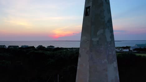 droning backwards revealing a beautiful sunset and sky over bald head island north carolina