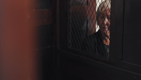 priest, talking and listening in confession booth