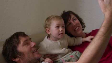 side view of family taking picture in living room at home