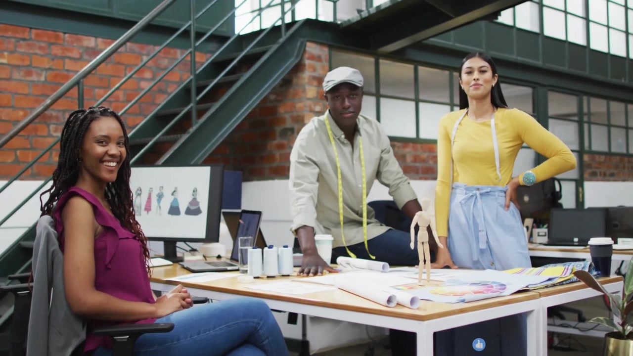 Fashion designers posing in studio starting social icons cascading over designs showing feedback