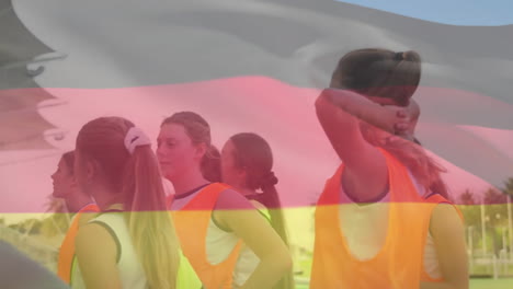 animation of germany and european flag over diverse coach discussing with female players