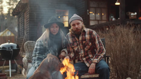 Portrait-of-Couple-with-Dog-by-Bonfire