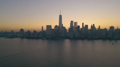 dawn breaks over new york city, sunrise over manhattan financial district, beautiful morning glow