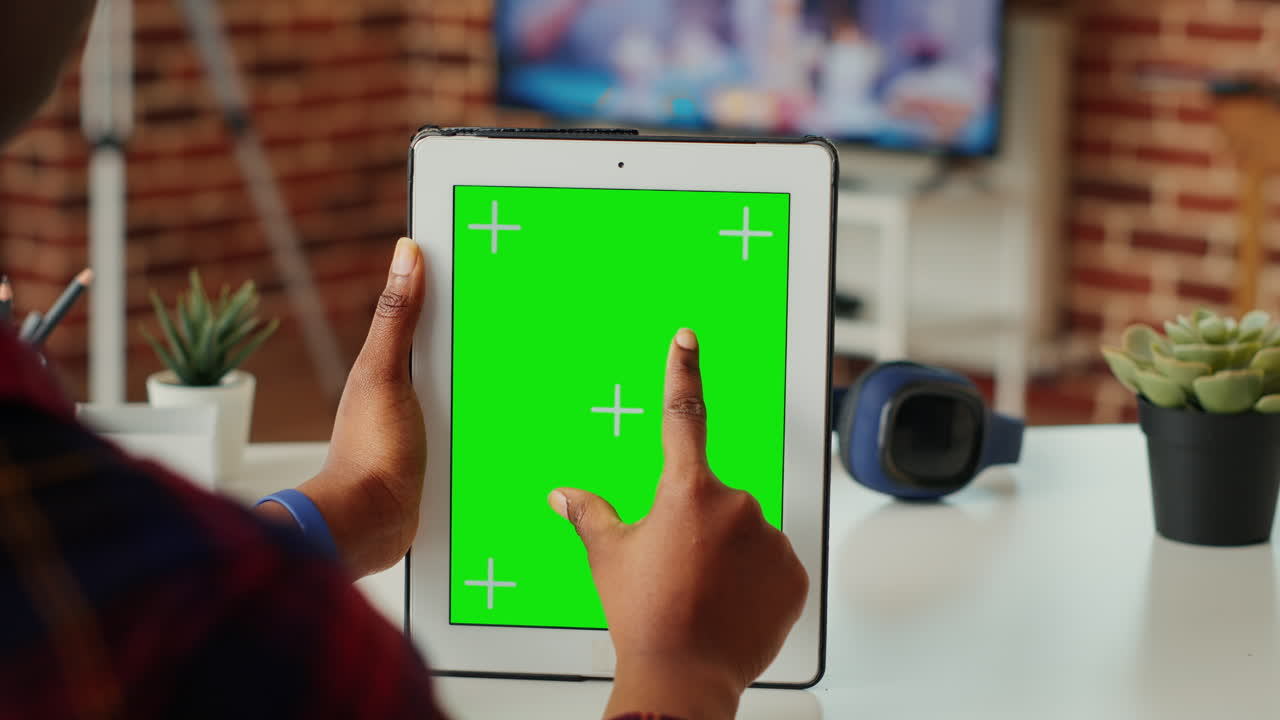 Female manager using greenscreen display on modern tablet