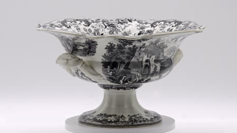 this decorative antique bowl features detailed patterns and elegant handles, highlighting exceptional craftsmanship.