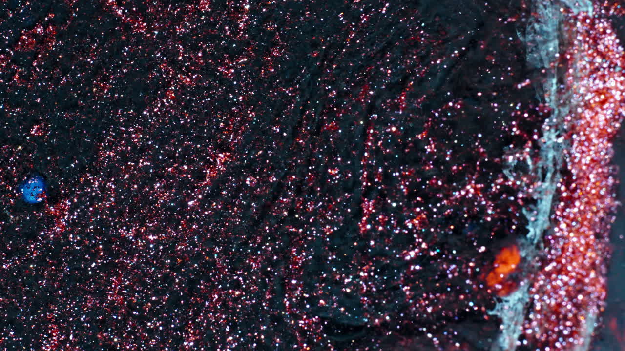 Macro shot of red substance dissolving in liquid, swirling motion
