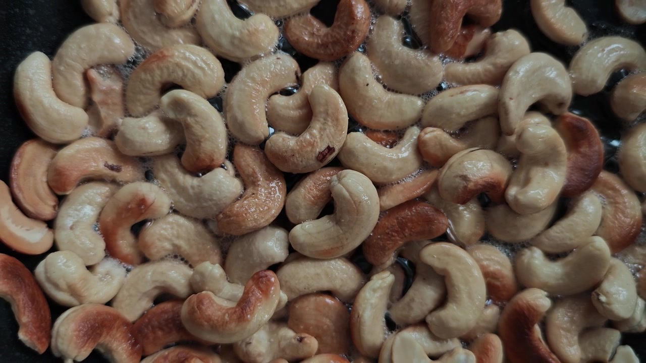 Ultra Cinematic Slow Motion Cashew Roasting in Black Pan with Olive Oil Sparks, Macro Food Art Close-Up, Crunchy Golden Transformation, Gourmet Kitchen ASMR Visual Feast 4K HDR Viral Stock Footage NOW