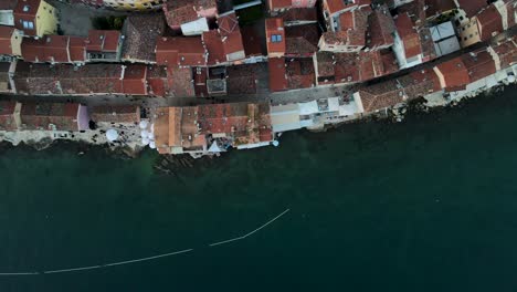 the adriatic sea meets land at the island-city or rovinj, croatia in this top-down drone shot