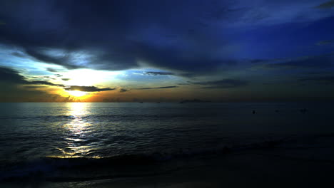 standing and looking at the sunrise in da nang while people are walking around in the morning.