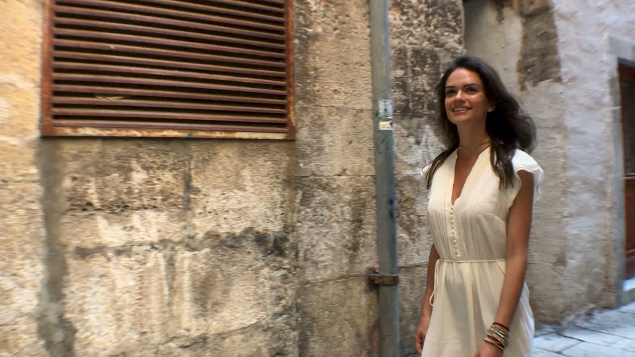 A woman exploring a historic European alleyway