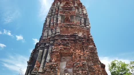 vertical pan shot: buddhist temple at the old the historic city of ayutthaya thailand