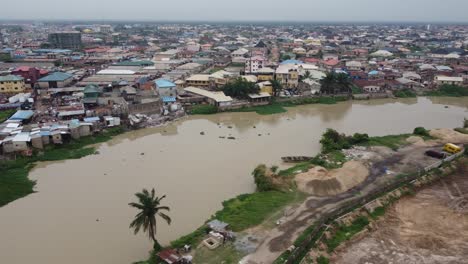 aeriel shot of a landlocked urban settlement near a river