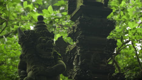 ancient stone statue covered with moss in the sacred monkey forest sanctuary in ubud, bali, indonesia