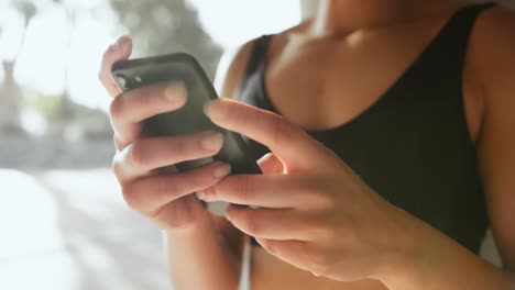 mid section of young african american woman using mobile phone in the city 4k