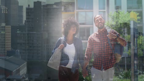 African-american-couple-holding-hands-while-walking-on-the-street-against-cityscape