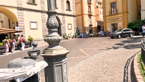 people and vehicles in a bustling town square