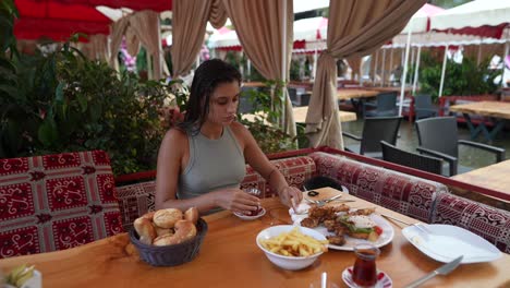 woman enjoying a meal at an outdoor cafe