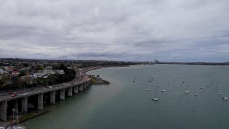 aerial shot of northcote point with state highway and traffic along the oneoneroa shoal bay in auckland, new zealand