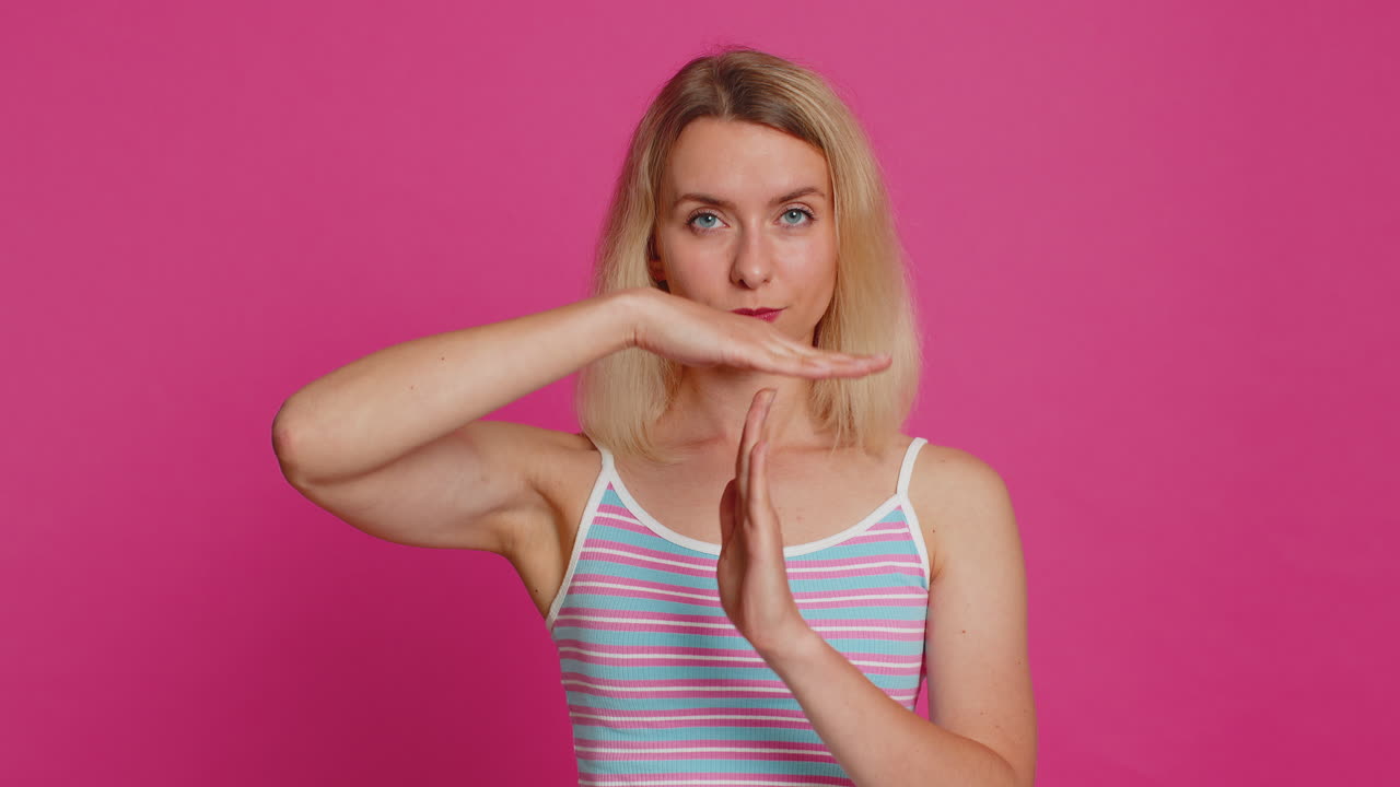 Tired upset woman showing pause gesture limit or stop sign time out take a break relax rest