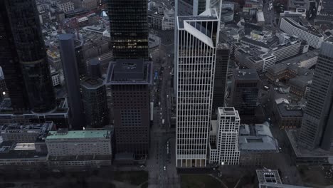 modern business city borough from height. tilt down on traffic in streets. vehicles passing by tall buildings. frankfurt am main, germany