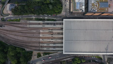 Aerial-birds-eye-overhead-top-down-panning-view-of-St-Pancras-train-station-in-Camden-borough.-Multiple-railway-tracks-and-roof-covered-platforms.-London,-UK