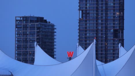 red w sign of woodward's building as seen on the roof of canada's place, vancouver, canada