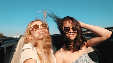 two friends enjoying a road trip in a convertible