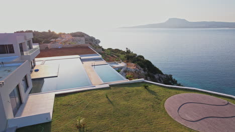 stunning coastal villa with infinity pool overlooking the sea at sunset