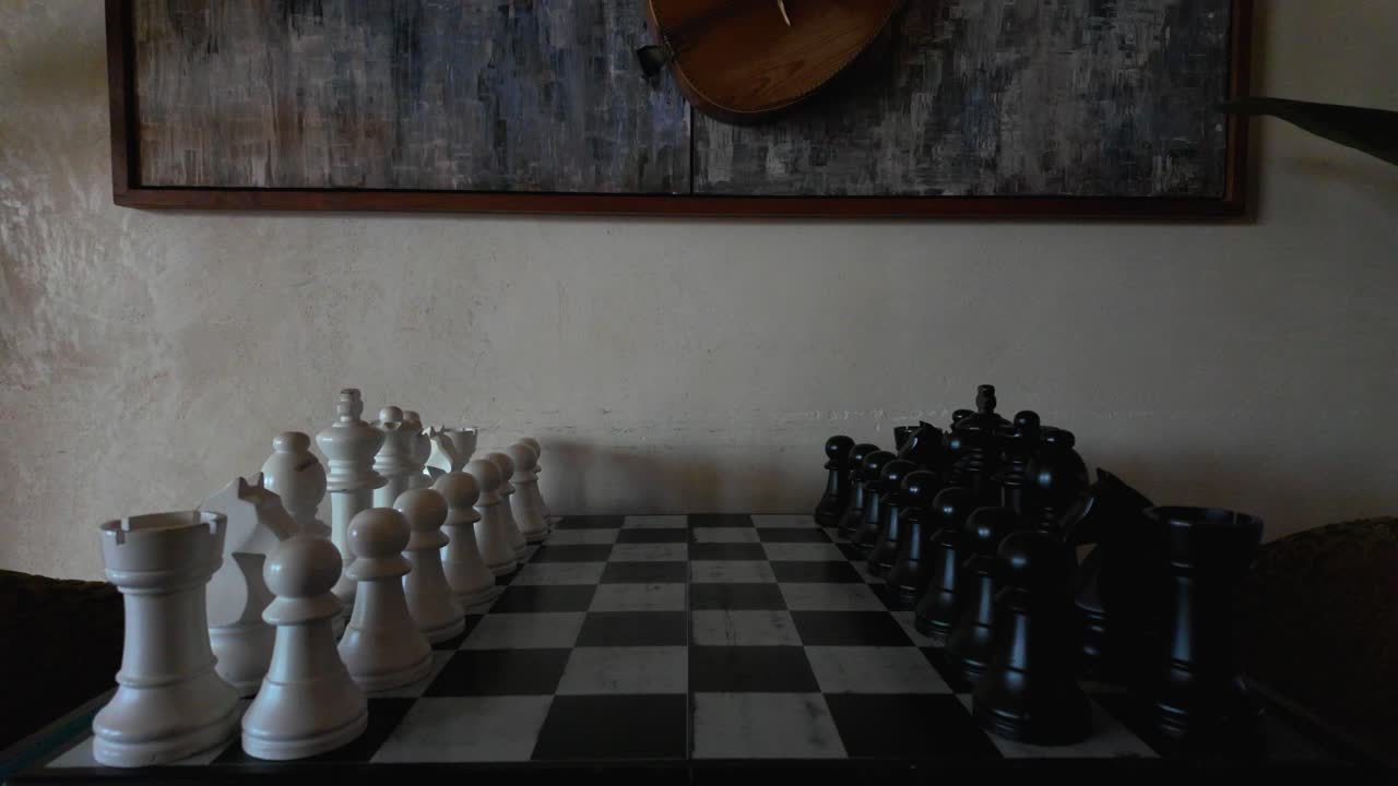 Slow-motion video of chess table with black and white pieces