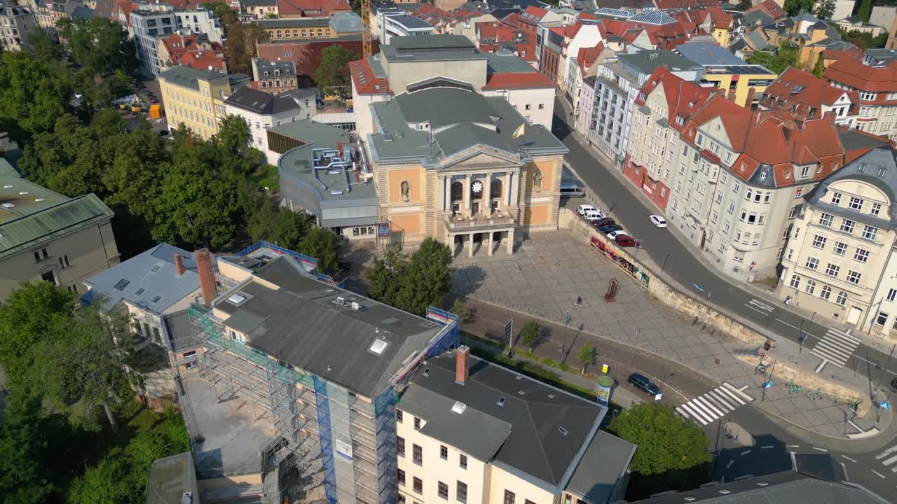 Fountains are cascading in front of the opera house on a sunny day in halle saale, germany. Lovely aerial view flight drone top down Above view
