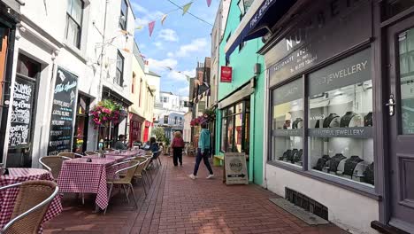 people walking past shops and cafes