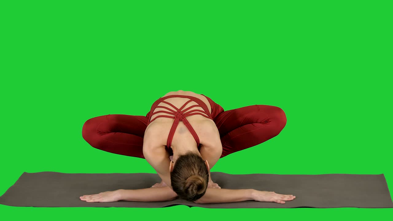 Fitness woman training yoga doing exotic pose on a Green Screen, Chroma Key