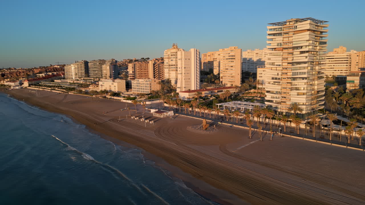 Aerial drone view of the Mediterranean Sea and the city of Alicante, Spain at sunset