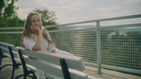 Smiling-Woman-On-Bench-Thinking